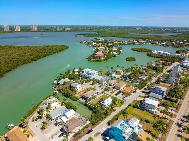 Aerial overview of property's location with nearby suburban area and a large body of water