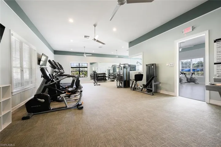 Exercise room featuring recessed lighting and a ceiling fan