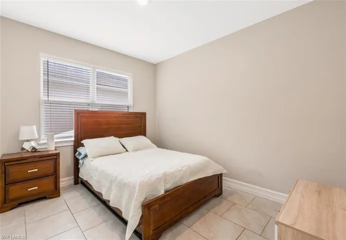 Bedroom with light tile patterned floors