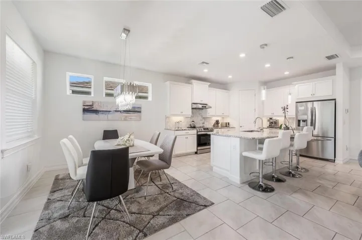 Dining area with a chandelier and light tile patterned floors