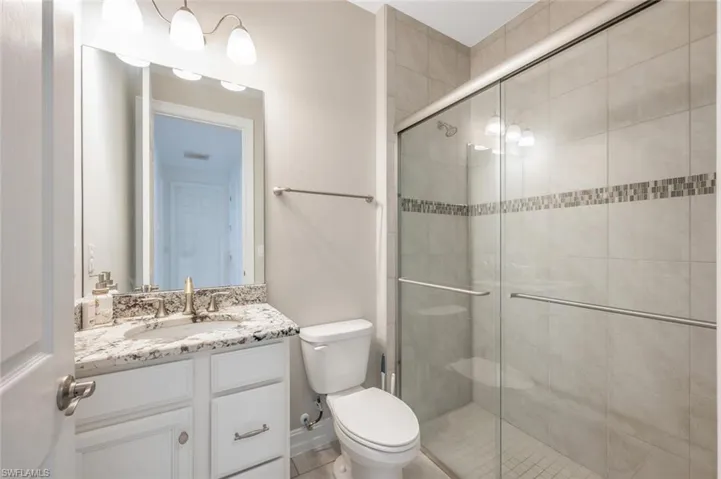 Bathroom featuring vanity and a stall shower