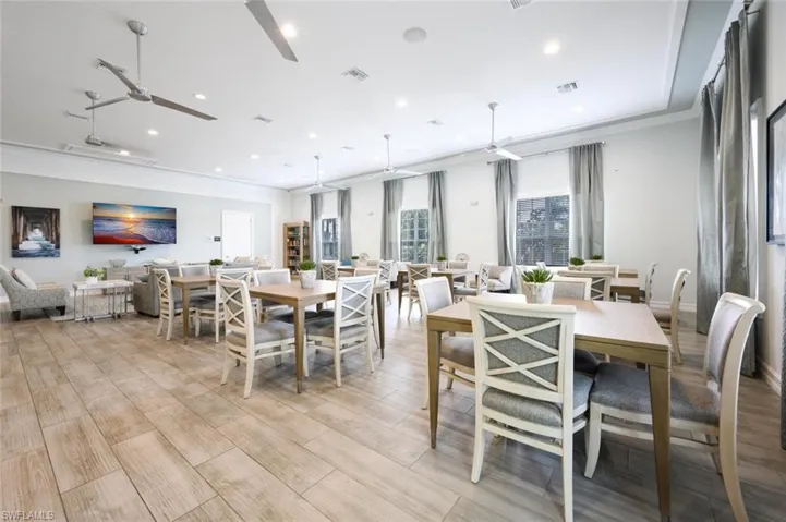 Dining room with a ceiling fan, light wood-style flooring, crown molding, and recessed lighting