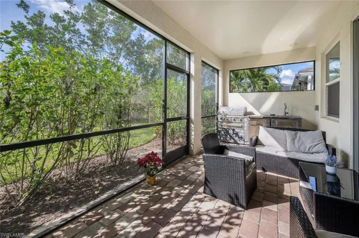 Sunroom featuring an outdoor kitchen and area to lounge and a sink