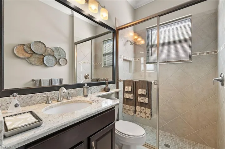 Second full bath with framed mirror, and no tub to step over to shower!