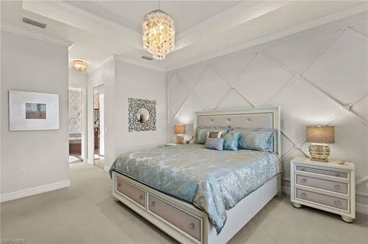 Tray ceiling, crown molding, to die for wood accent wall, mirrored closet His'N'Her walk-in closet doors combine to make a luxurious primary bedroom!