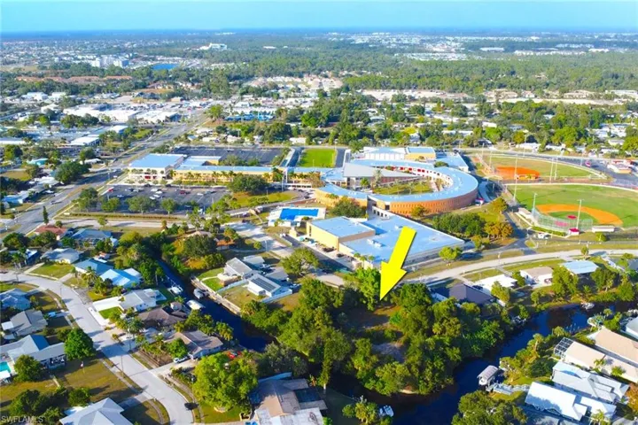 Aerial view of property's location featuring nearby suburban area