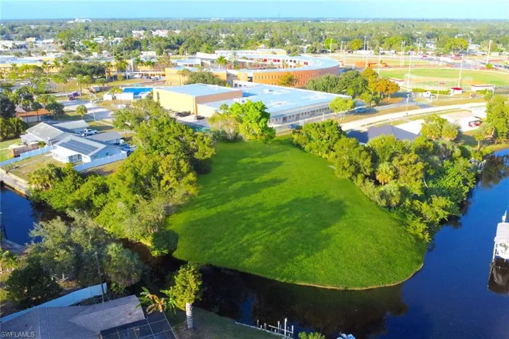 Aerial view of a nearby body of water and a tree filled landscape