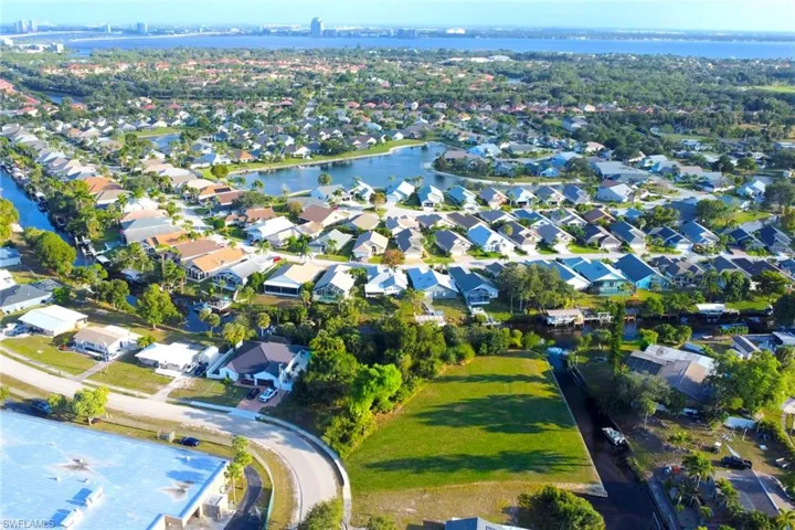 Aerial view of property's location featuring nearby suburban area and a large body of water