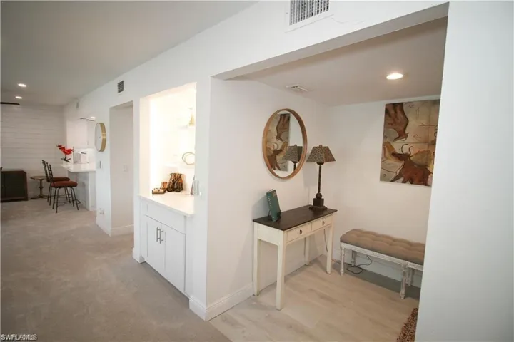 Hall with recessed lighting and light wood-style floors