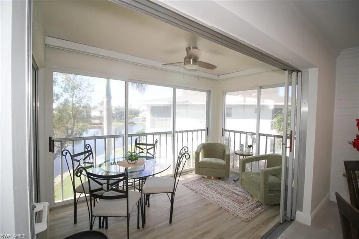 Sunroom / solarium featuring ornamental molding, healthy amount of natural light, and a water view