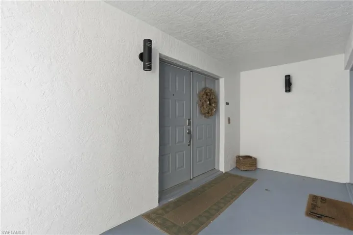 Property entrance featuring stucco siding - Virtually Edited Image