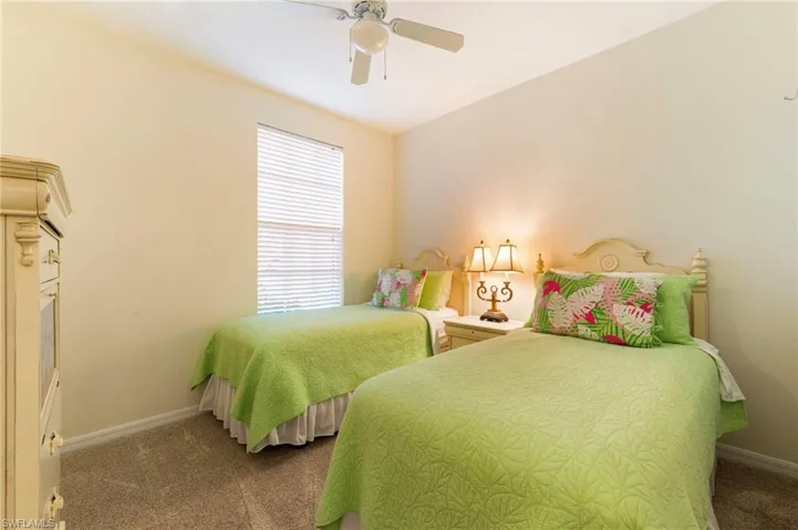Carpeted bedroom with baseboards and ceiling fan