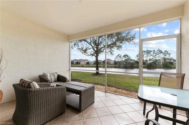 Sunroom / solarium featuring a water view and outdoor dining space