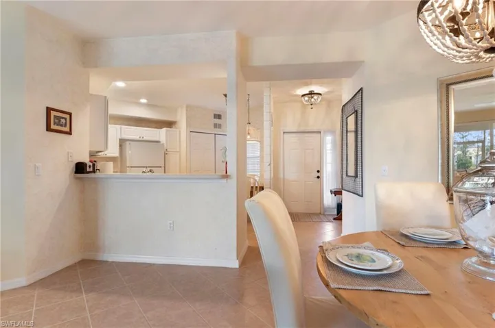 Dining room featuring a chandelier, light tile patterned floors, and plenty of natural light
