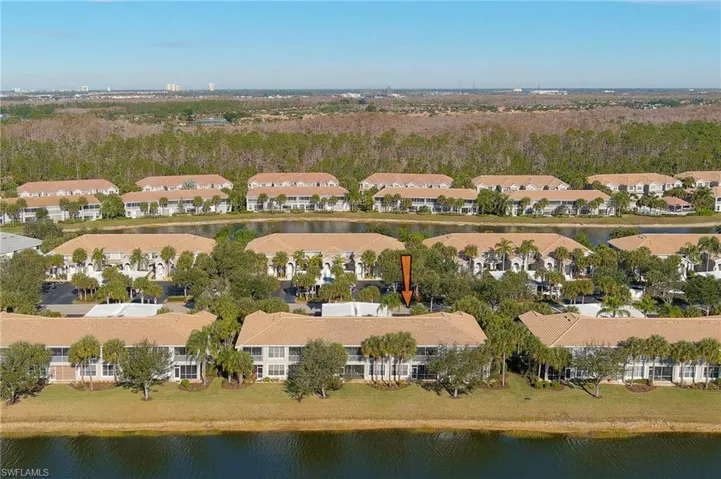 Aerial view of property's location featuring nearby suburban area and a nearby body of water