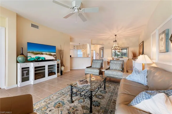 Living area featuring light tile patterned flooring and ceiling fan