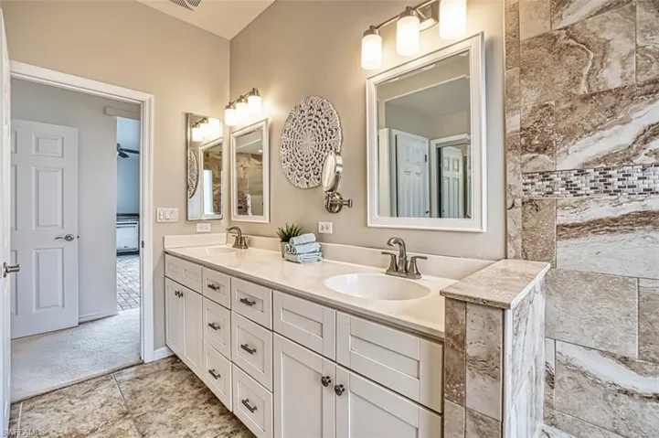 Sitting room with ceiling fan and light colored carpet