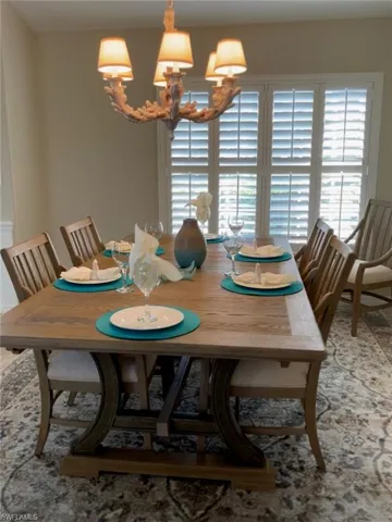 Dining space featuring a healthy amount of sunlight and an inviting chandelier
