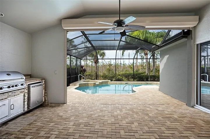 Outdoor kitchen, sink, refrigerator and a grill