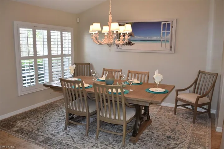 Dining room with a notable chandelier and tile patterned floors