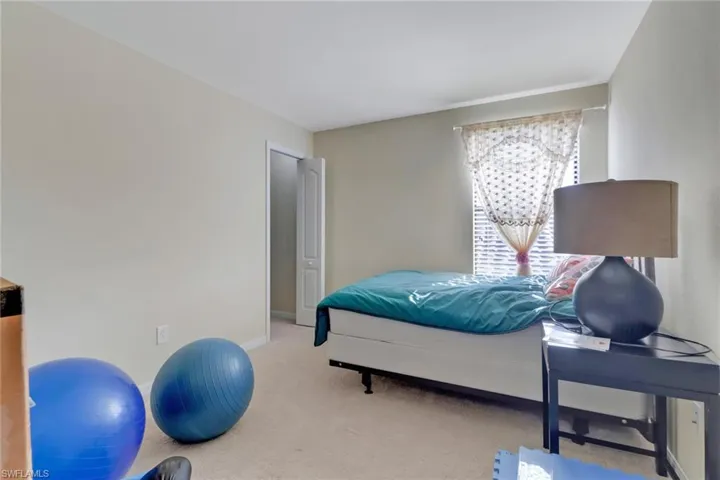 Bedroom with light carpet