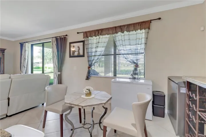 Dining area with crown molding and light tile patterned floors