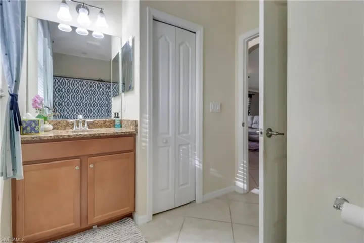 Bathroom with tile patterned flooring and vanity