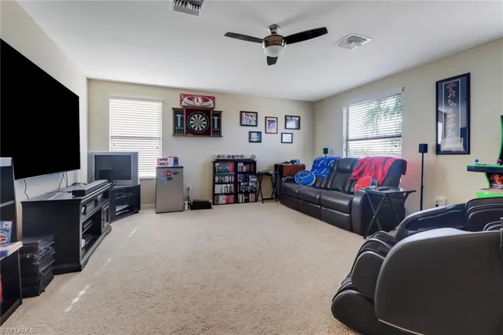 Living room with ceiling fan and carpet floors