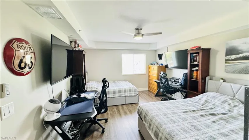 Bedroom with light hardwood / wood-style floors and ceiling fan