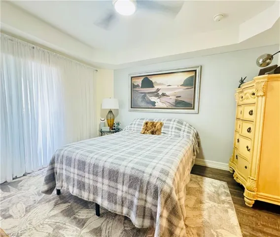 Bedroom with dark wood-type flooring and ceiling fan