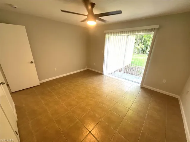 Unfurnished room with a ceiling fan and light tile patterned floors
