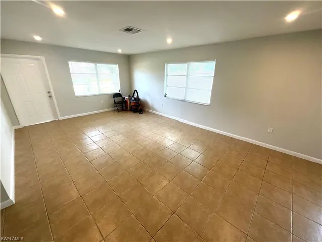 Spare room with light tile patterned flooring and recessed lighting