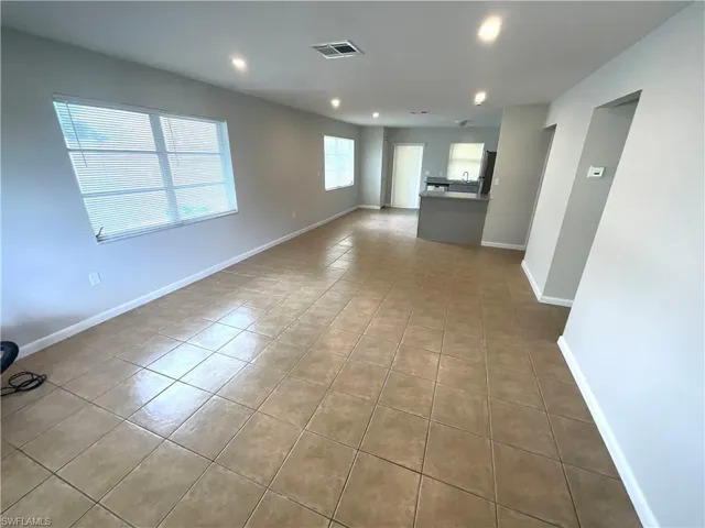 Unfurnished living room featuring light tile patterned floors and recessed lighting
