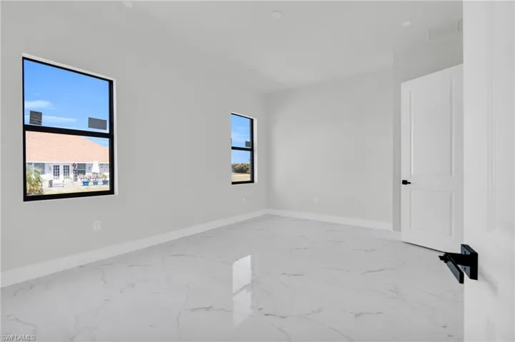 Spare room with baseboards, marble finish floor, and visible vents