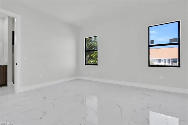 Empty room with baseboards and marble finish floor