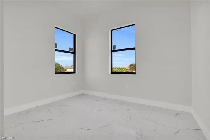 Spare room with baseboards and marble finish floor