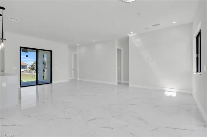 Spare room featuring recessed lighting, baseboards, visible vents, and marble finish floor