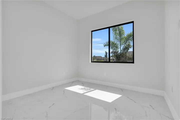 Empty room featuring baseboards and marble finish floor