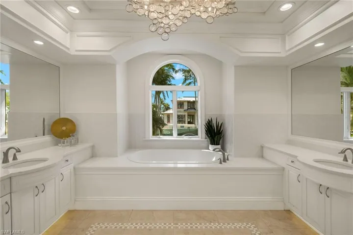 Bathroom with a garden tub, tile patterned flooring, a sink, and recessed lighting