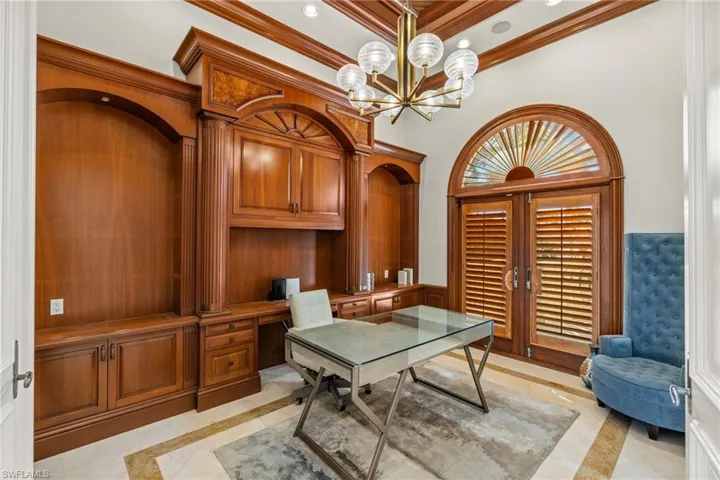 Home office with ornamental molding, recessed lighting, a notable chandelier, and built in desk