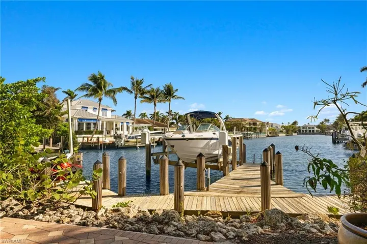 View of dock with a water view and boat lift