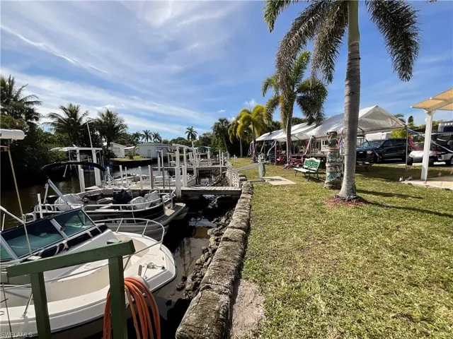 Dock area featuring a water view and a yard