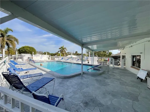 Pool with a patio area and fence