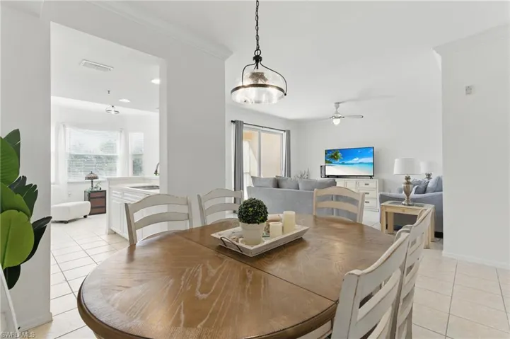 Dining room featuring a wealth of natural light, visible vents, light tile patterned floors, and ornamental molding