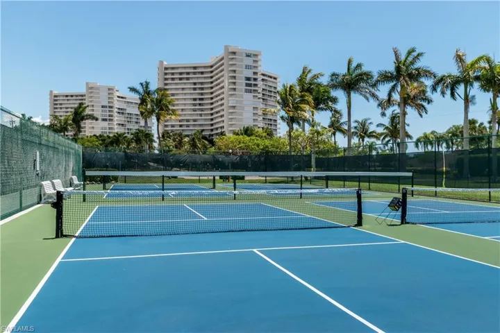 View of tennis court with community basketball court