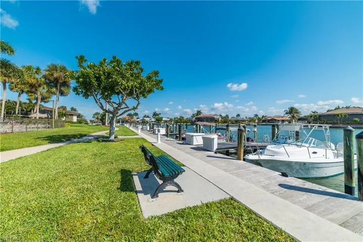 Dock area with a yard, a water view, and a residential view