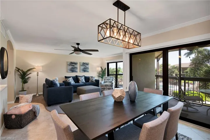 Dining space with crown molding and a ceiling fan
