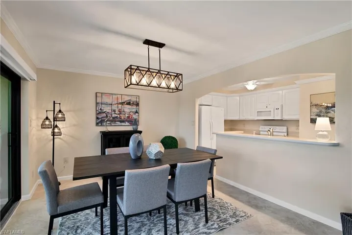 Dining area featuring arched walkways and ornamental molding