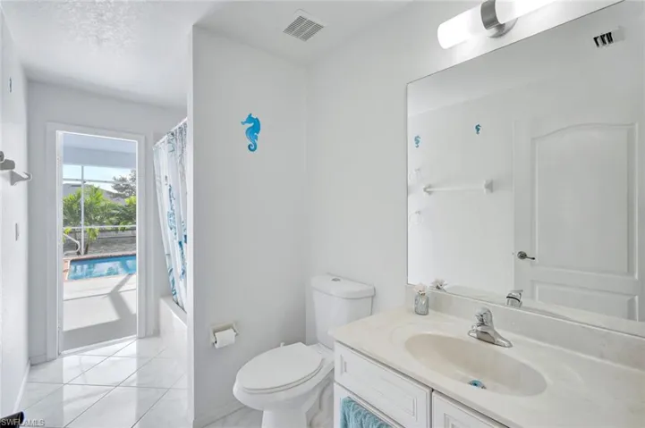Full bathroom featuring shower / bath combination with curtain and vanity