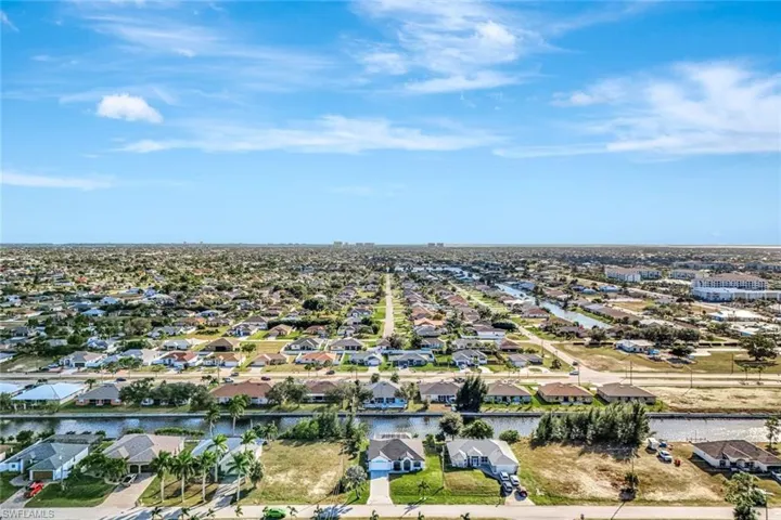 Aerial view of property's location with nearby suburban area and a nearby body of water